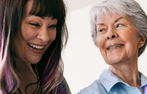 Young woman and older woman smiling together image