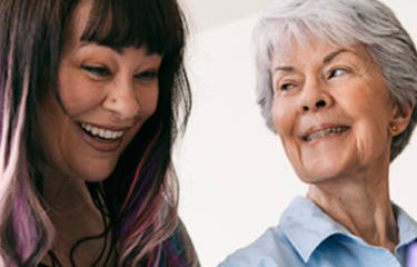 Young woman and older woman smiling together image