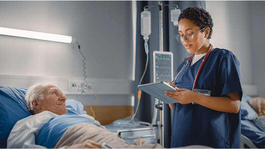 Elderly man in hospital bed being checked by a healthcare professional image