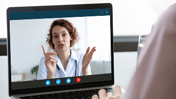 Healthcare professional on a laptop screen during a video call image