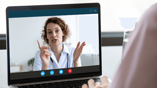 Healthcare professional on a laptop screen during a video call image