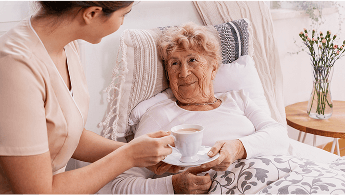 Elderly lady with a cup of tea in bed image