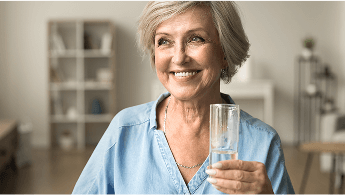 Woman smiling and holding an empty glass image