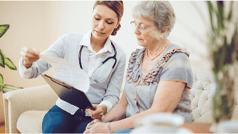 Healthcare professional and patient sat down reviewing results image