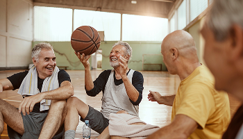Older men sat down on a basketball court image