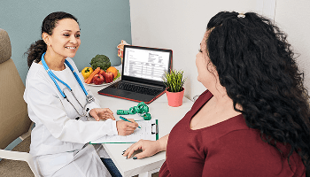 Healthcare professional and patient sat down talking during a consultation image