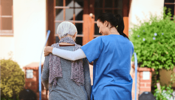 Healthcare professional bandaging up a patient's wrist image