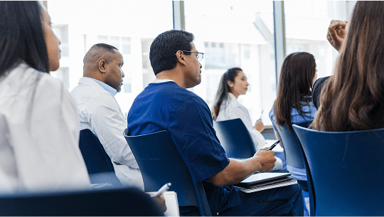 Healthcare professionals sat down in a seminar image