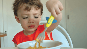 Child eating a bowl of spaghetti image