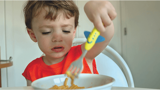 Child eating a bowl of spaghetti image