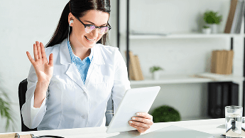 Healthcare professional having a video call at her desk using a tablet device image