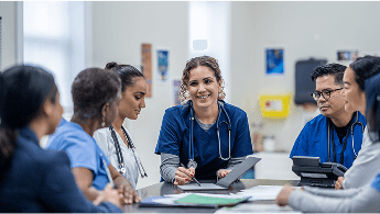 Healthcare professionals in discussion around a table image