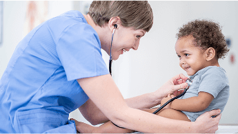 Healthcare professional examining a young, smiling child with a stethoscope image