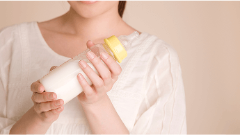 Woman holding a full baby bottle image