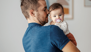 Baby being held by man image