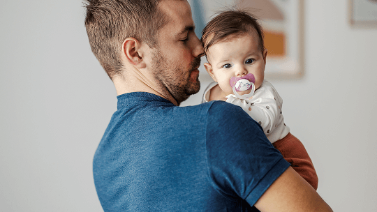 Baby being held by man image