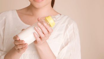 Woman holding a full baby bottle image