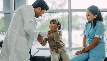 Child giving a healthcare professional a high-five image
