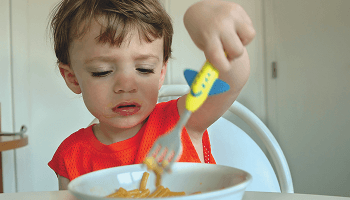 Child eating a bowl of spaghetti image