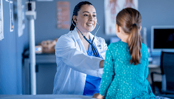 Healthcare professional examing a child in a hospital image