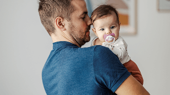 Baby being held by man image