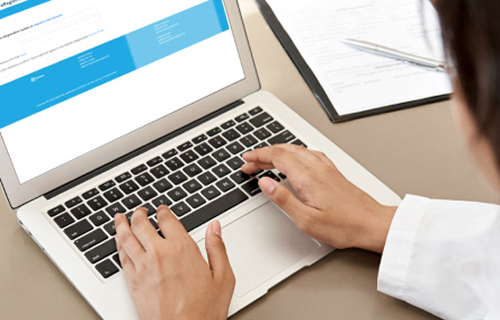 Healthcare profeesional using a laptop image