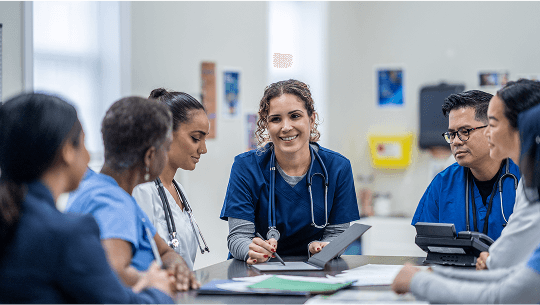 Healthcare professionals in discussion around a table image